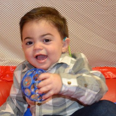 boy smiling with toy