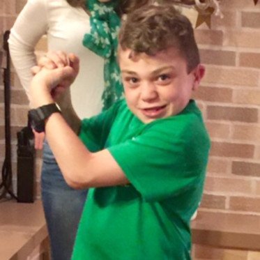 boy in green shirt smiling