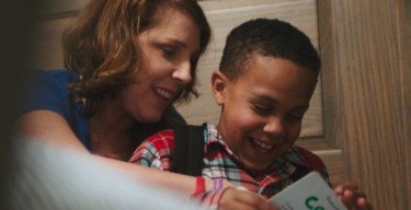 mother and son reading a book together