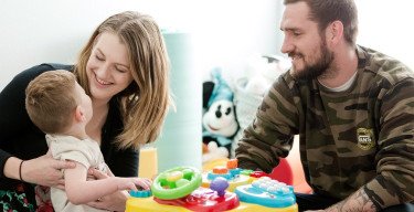 mom and dad playing with son