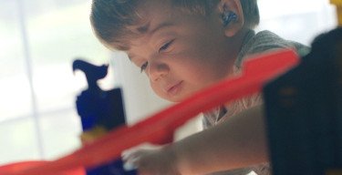 young boy playing with toys