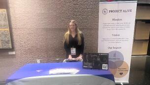 woman standing behind a table