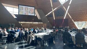 people sitting at tables listening to presentation