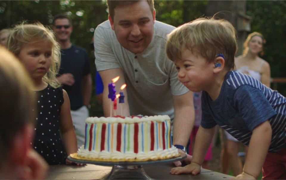 Finn blowing out birthday candles at birthday party